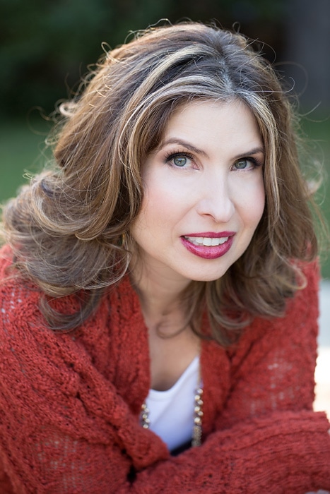 Jillian Leslie, a woman with brown hair and a red cardigan.