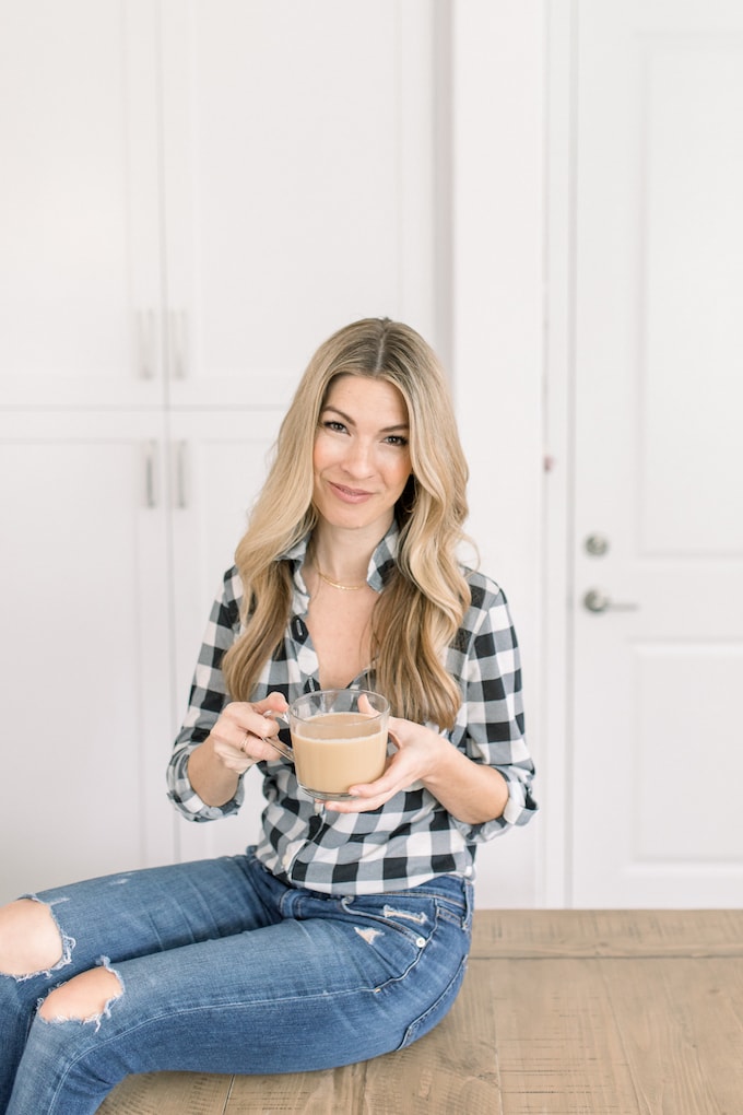 Kelsey Murphy, a blonde woman holding coffee in jeans and plaid